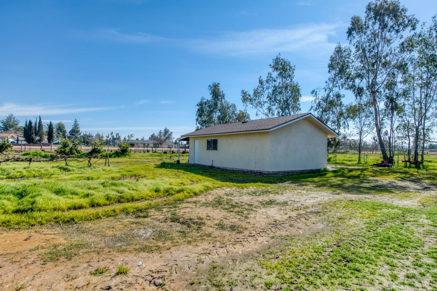 25540 Lynn Place, Unit B Madera, CA 93638 - Photo 28 of 37 a view of a house with a backyard