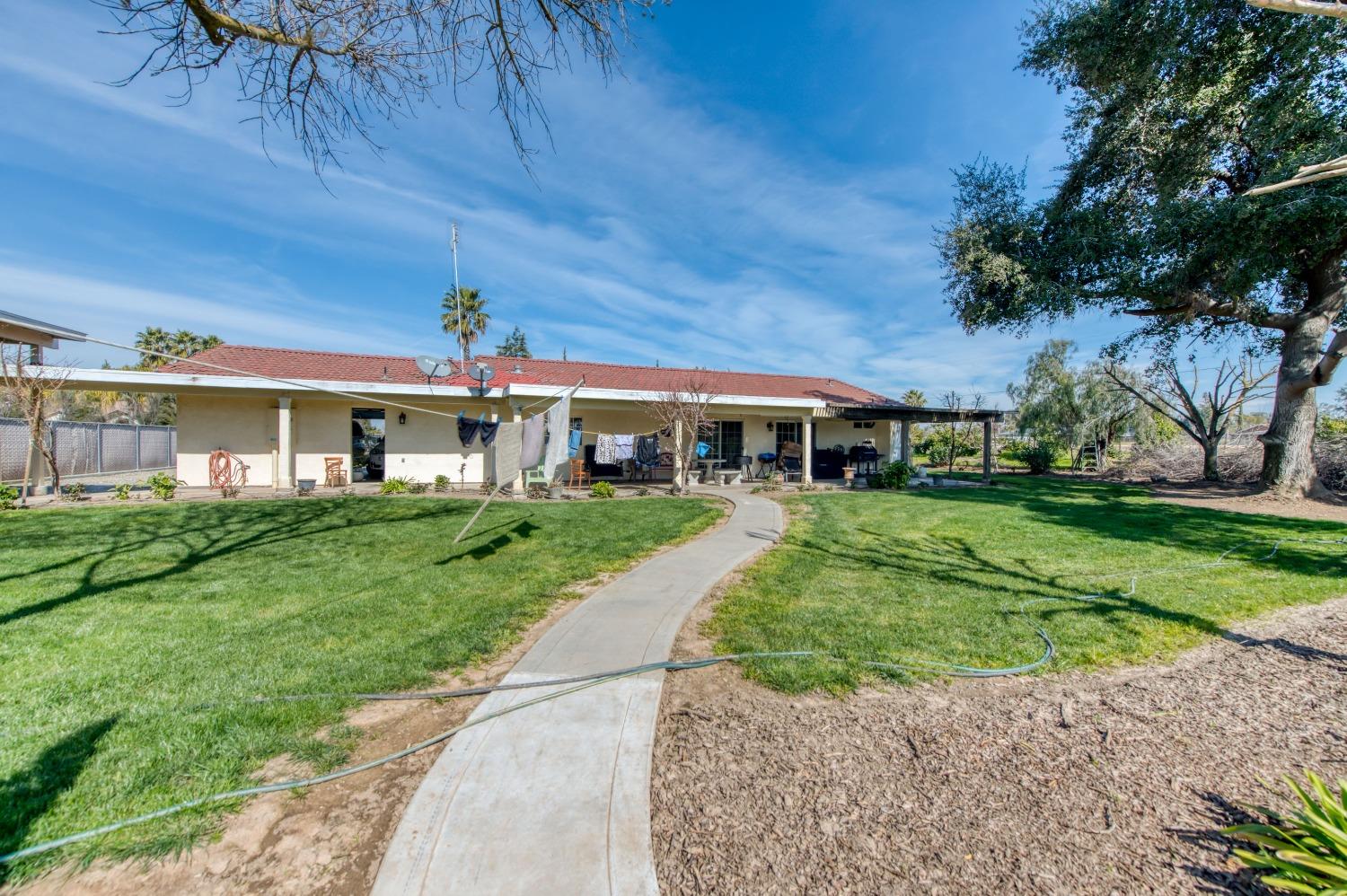 25540 Lynn Place, Unit B Madera, CA 93638 - Photo 31 of 37 a front view of a house with a yard