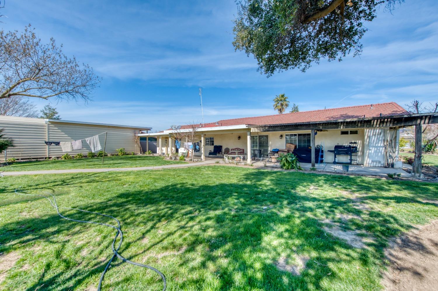 25540 Lynn Place, Unit B Madera, CA 93638 - Photo 32 of 37 a front view of a house with a garden
