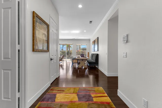 a living room with kitchen island furniture and a chandelier