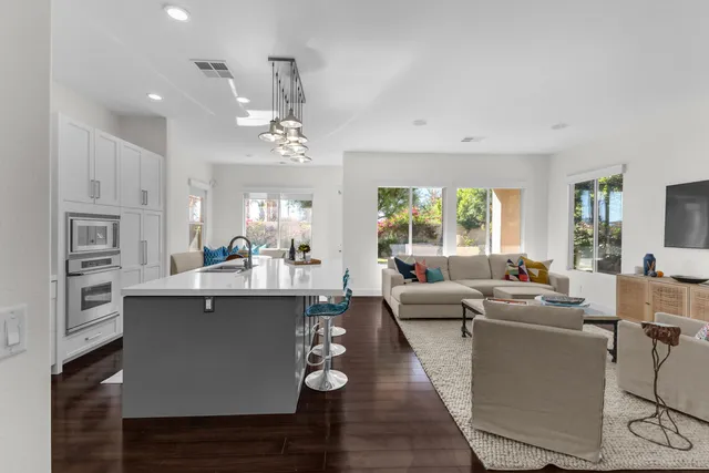a living room with furniture and large windows