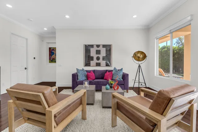 a kitchen with white cabinets and a refrigerator