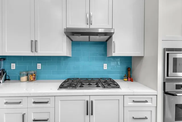 a kitchen with stainless steel appliances granite countertop a sink and refrigerator