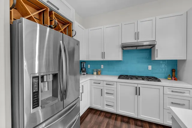 a kitchen with a table chairs stove and refrigerator