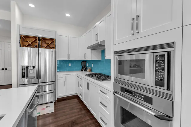 a living room with furniture kitchen view and a table