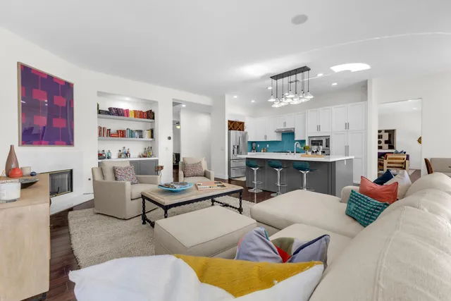 a bedroom with a bed a tv and wooden floor