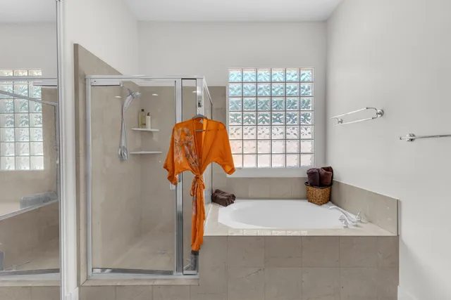 a view of a house with swimming pool and sitting area