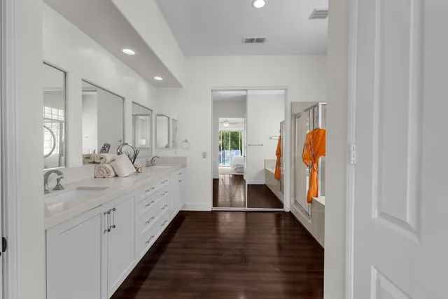 an aerial view of residential houses with outdoor space and street view