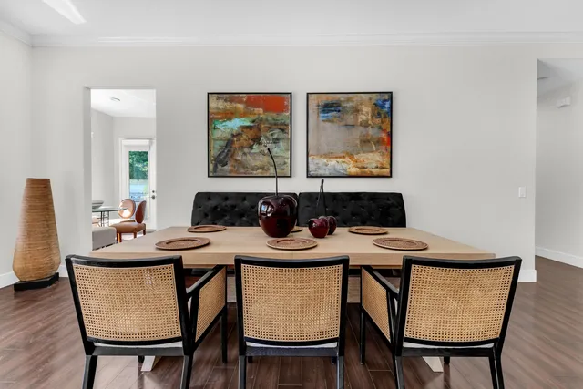 a view of a dining room with furniture and wooden floor