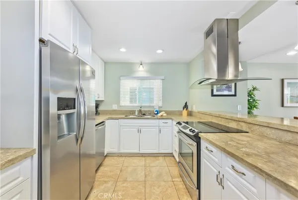 a kitchen with stainless steel appliances granite countertop a sink and stove