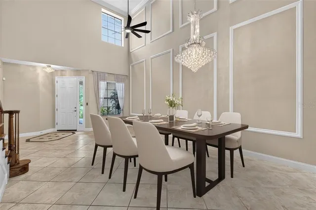 a kitchen with stainless steel appliances granite countertop a sink a stove a refrigerator cabinets and chairs