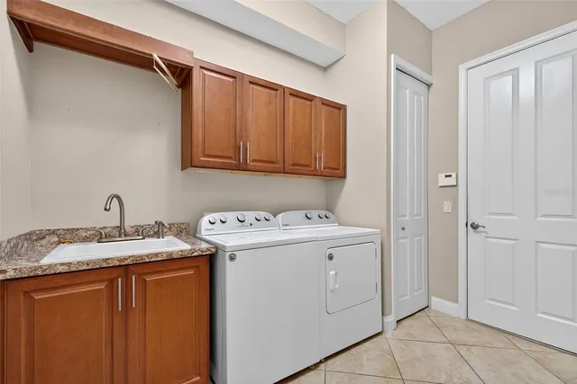 an empty room with wooden floor and ceiling fan