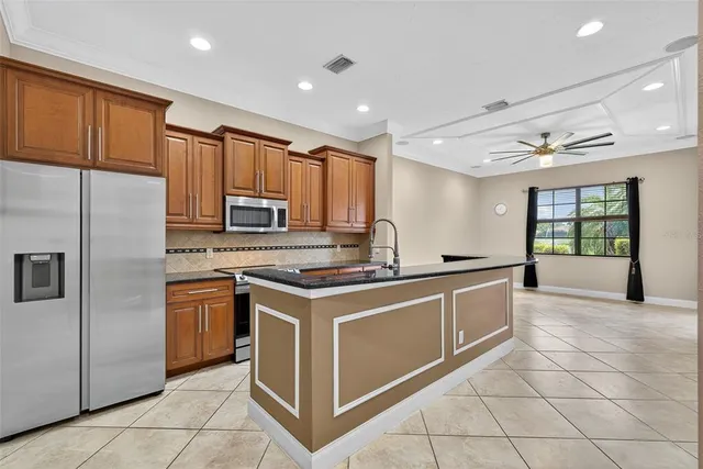 a bedroom with a large bed and a potted plant