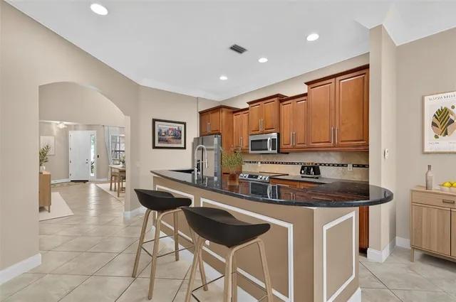an empty room with a window and a ceiling fan