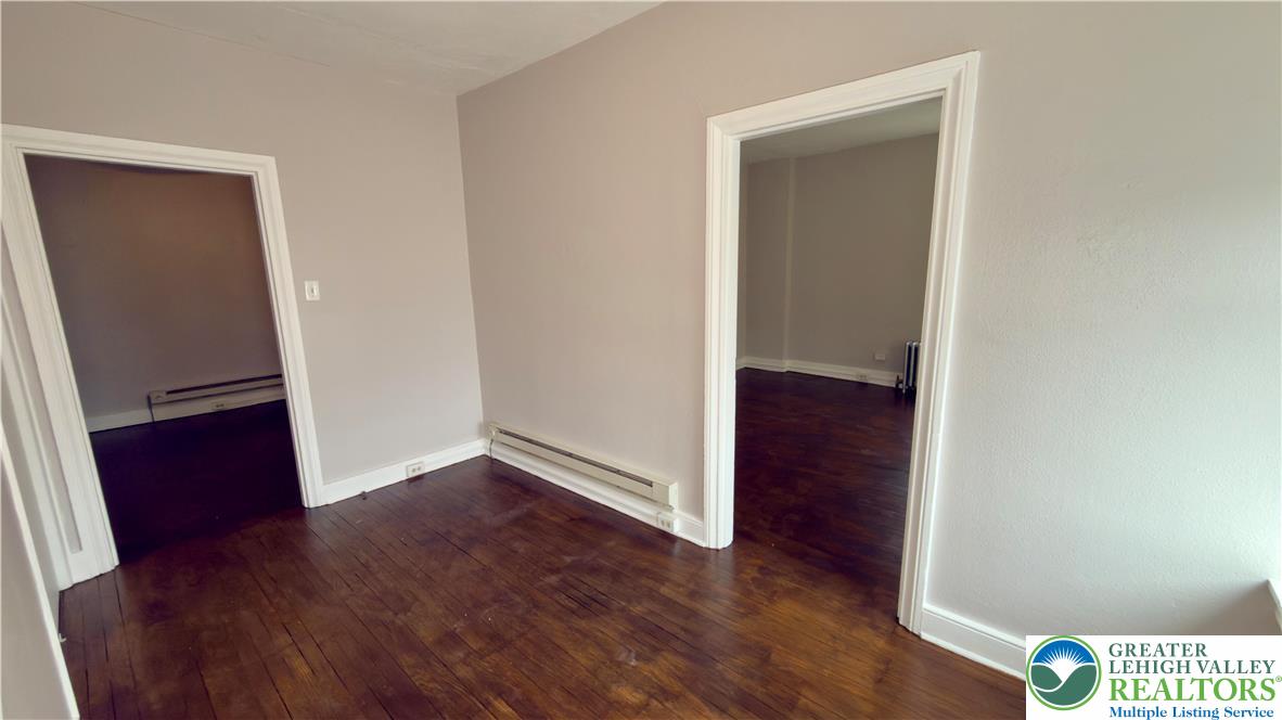 1236 Main Street, Unit 2 Hellertown, PA 18055 - Photo 11 of 29 an empty room with wooden floor and closet