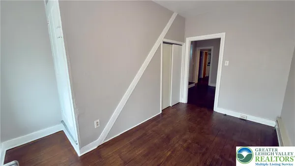 a view of an entryway with wooden floor