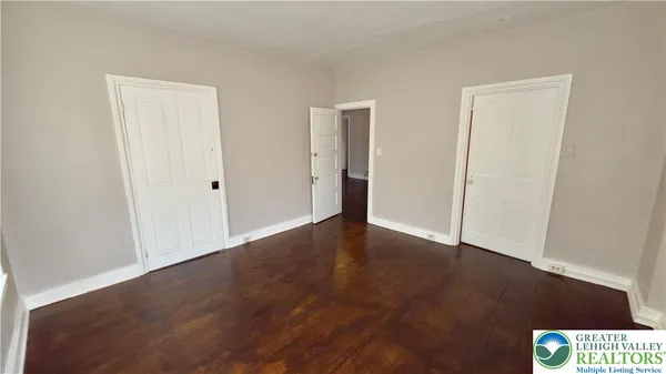 an empty room with wooden floor