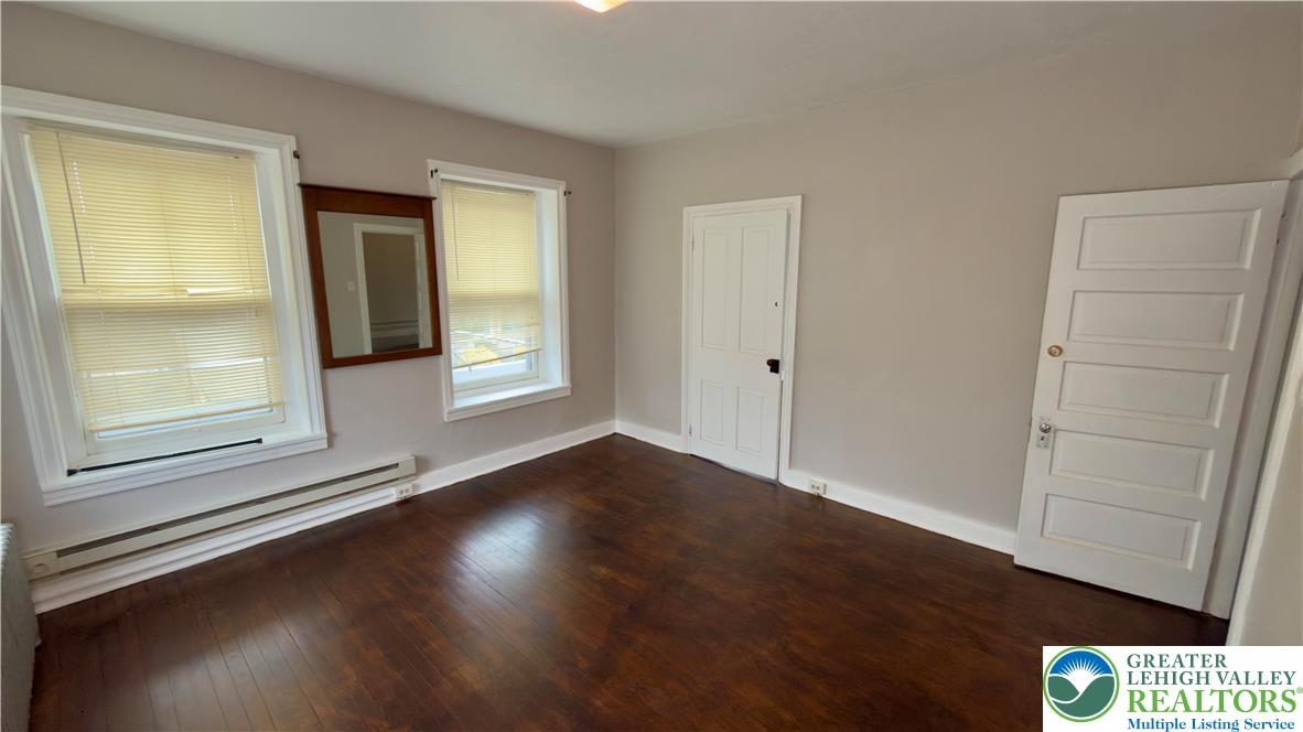 1236 Main Street, Unit 2 Hellertown, PA 18055 - Photo 15 of 29 an empty room with wooden floor and windows