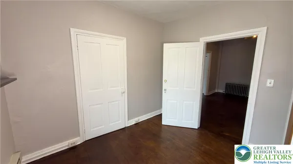 a view of an empty room and wooden floor