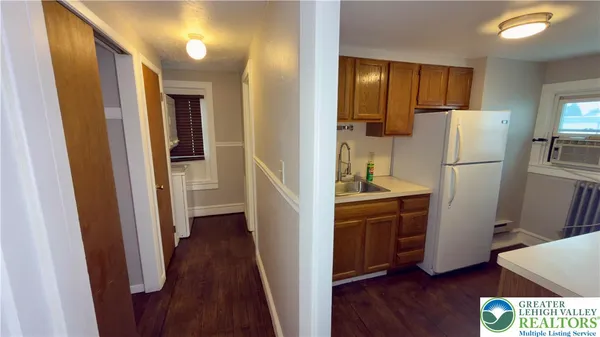 a kitchen with a refrigerator a sink and cabinets