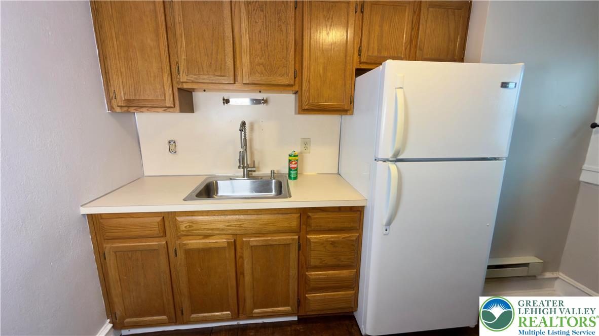1236 Main Street, Unit 2 Hellertown, PA 18055 - Photo 20 of 29 a white refrigerator freezer sitting in a kitchen
