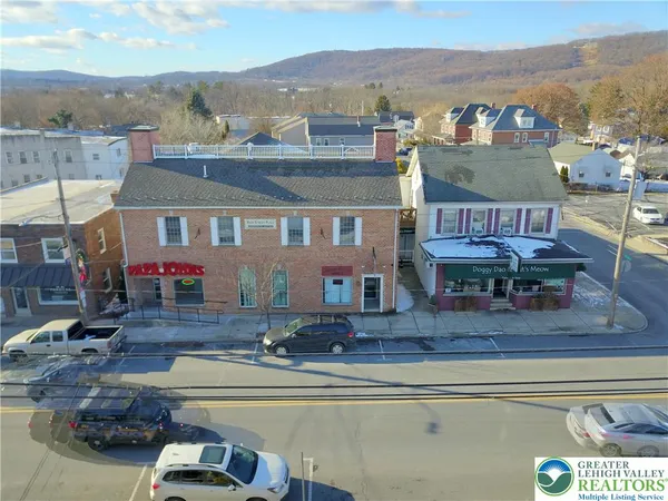 an aerial view of residential houses with outdoor space