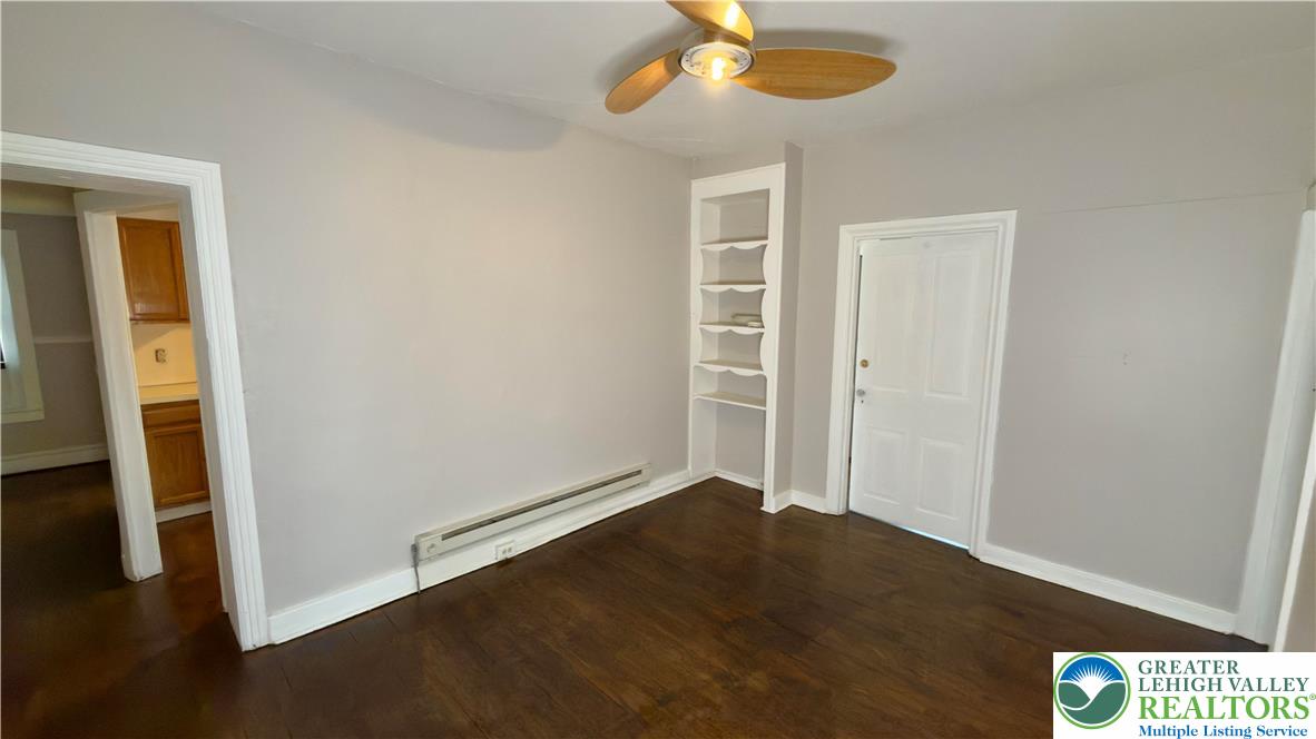 1236 Main Street, Unit 2 Hellertown, PA 18055 - Photo 7 of 29 an empty room with wooden floor closet and chandelier fan