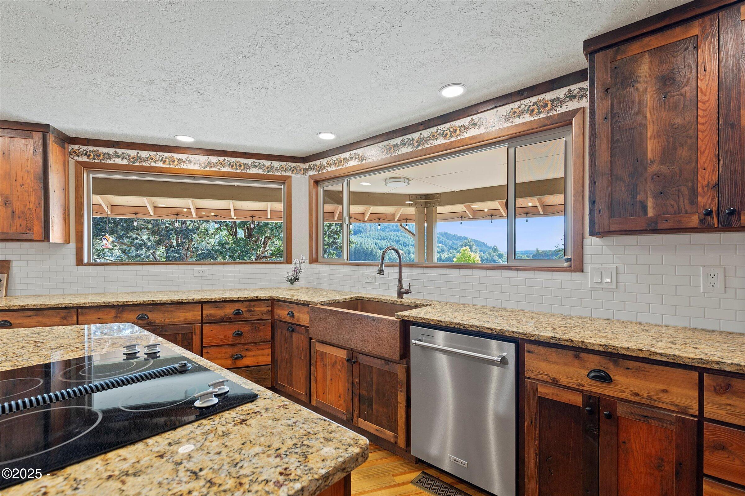 21560 Gooseneck Road Sheridan, OR 97378 - Photo 22 of 63 a kitchen with stainless steel appliances granite countertop a sink and wooden cabinets