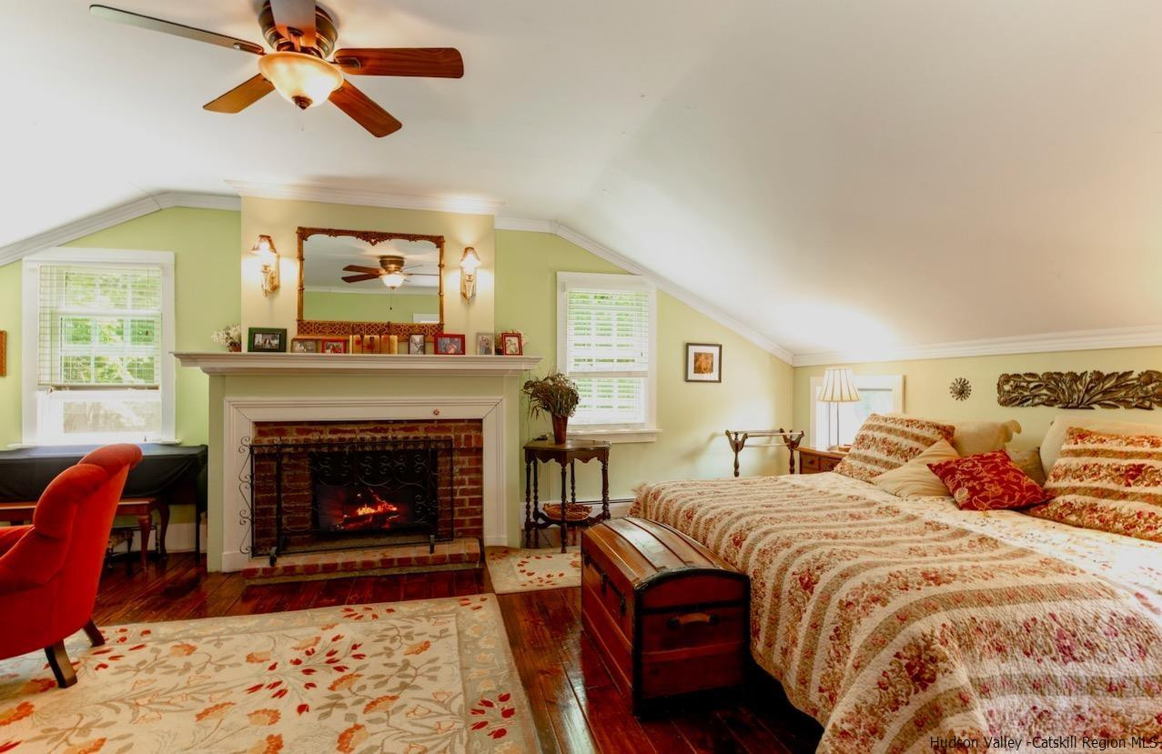 1182 Highway 208 Wallkill, NY 12589 - Photo 18 of 35 a bedroom with bed and a fireplace