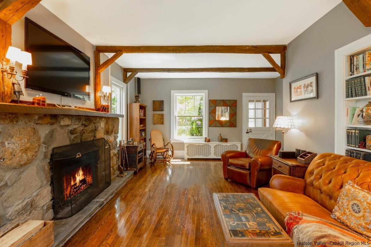 1182 Highway 208 Wallkill, NY 12589 - Photo 2 of 35 a living room with furniture a flat screen tv and a fireplace