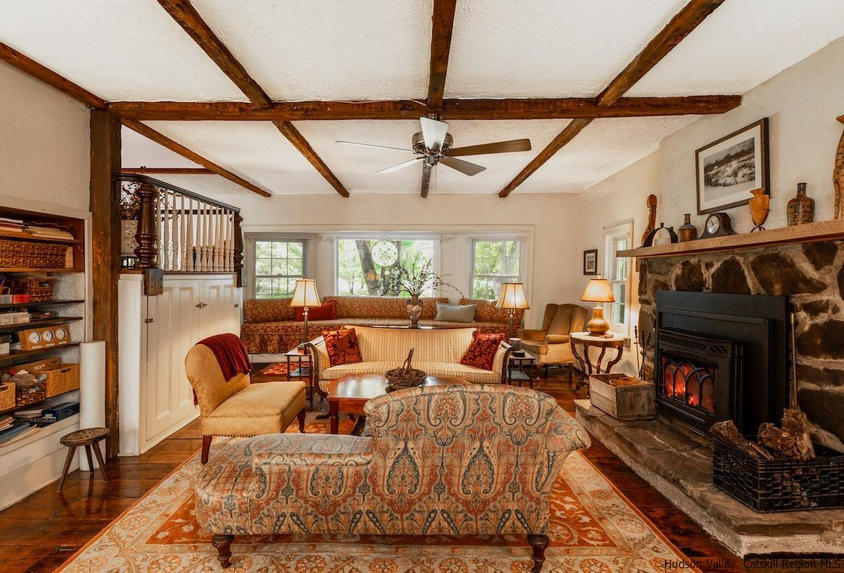 1182 Highway 208 Wallkill, NY 12589 - Photo 8 of 35 a living room with furniture a fireplace and a flat screen tv