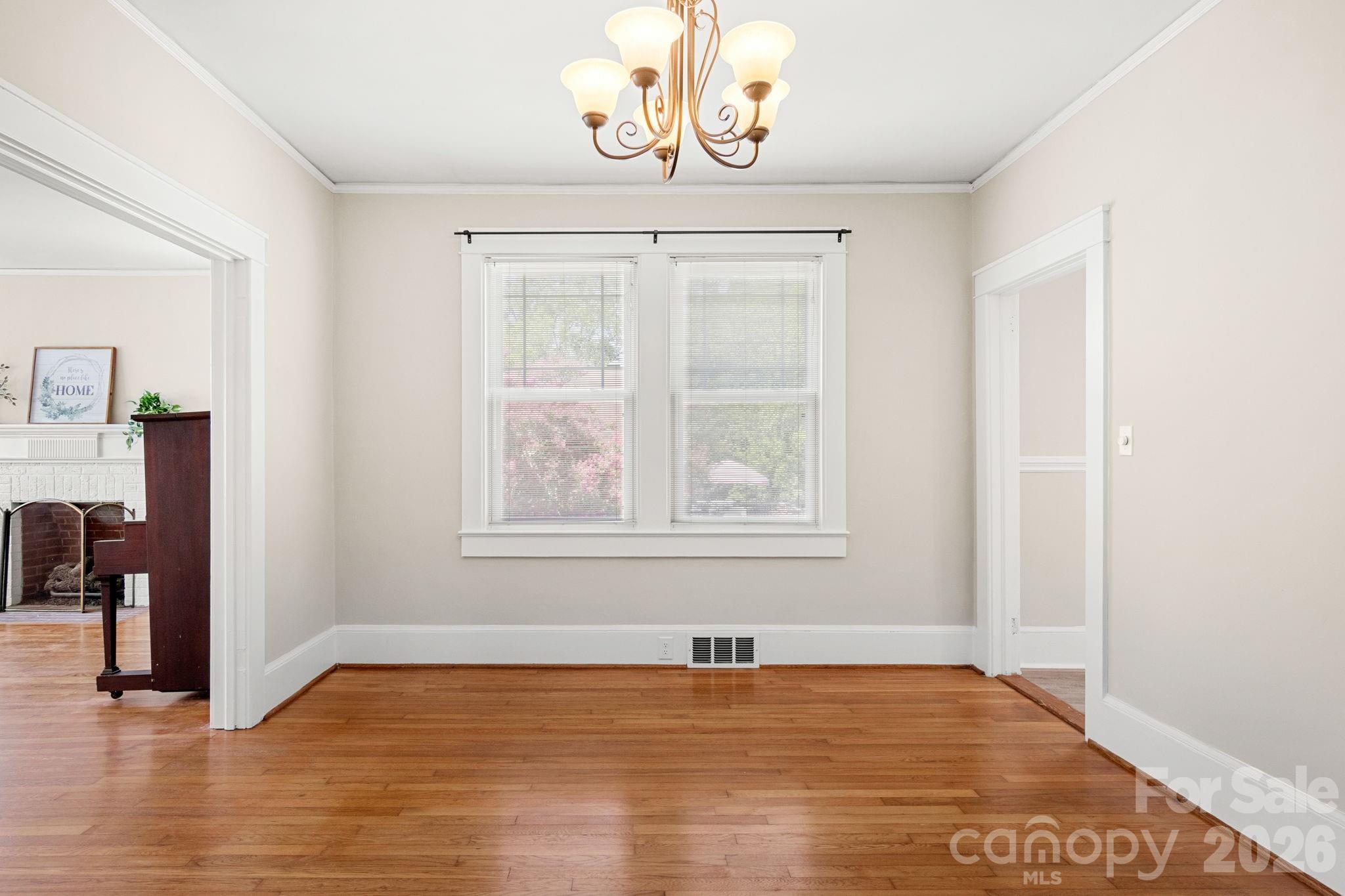 108 Reedy Street Chester, SC 29706 - Photo 7 of 42 an empty room with wooden floor closet and windows