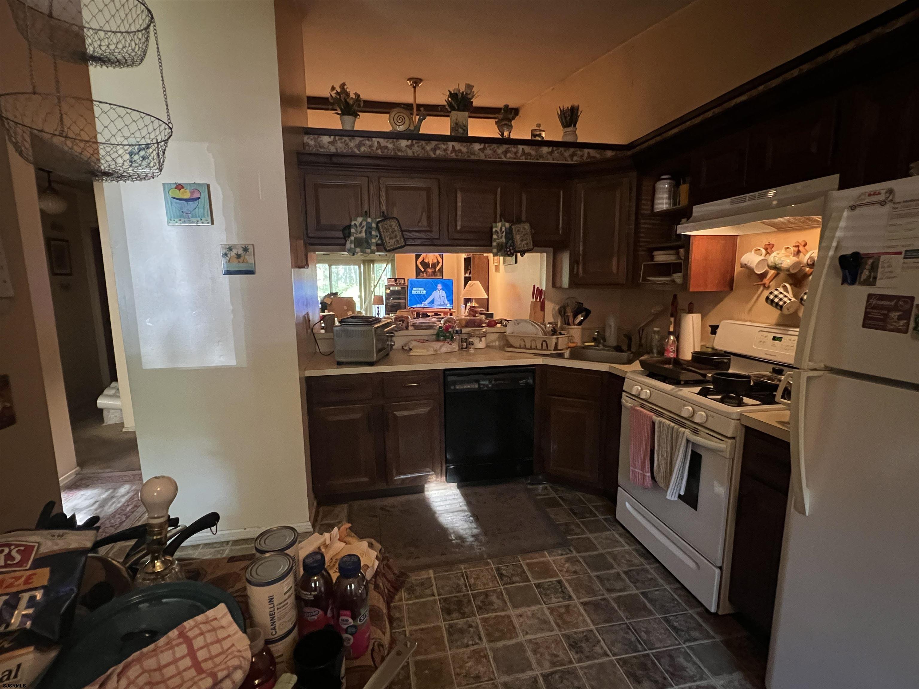 152 Club Place, Unit 152 Galloway Township, NJ 08205 - Photo 17 of 23 a kitchen with stainless steel appliances kitchen island granite countertop a stove and a refrigerator