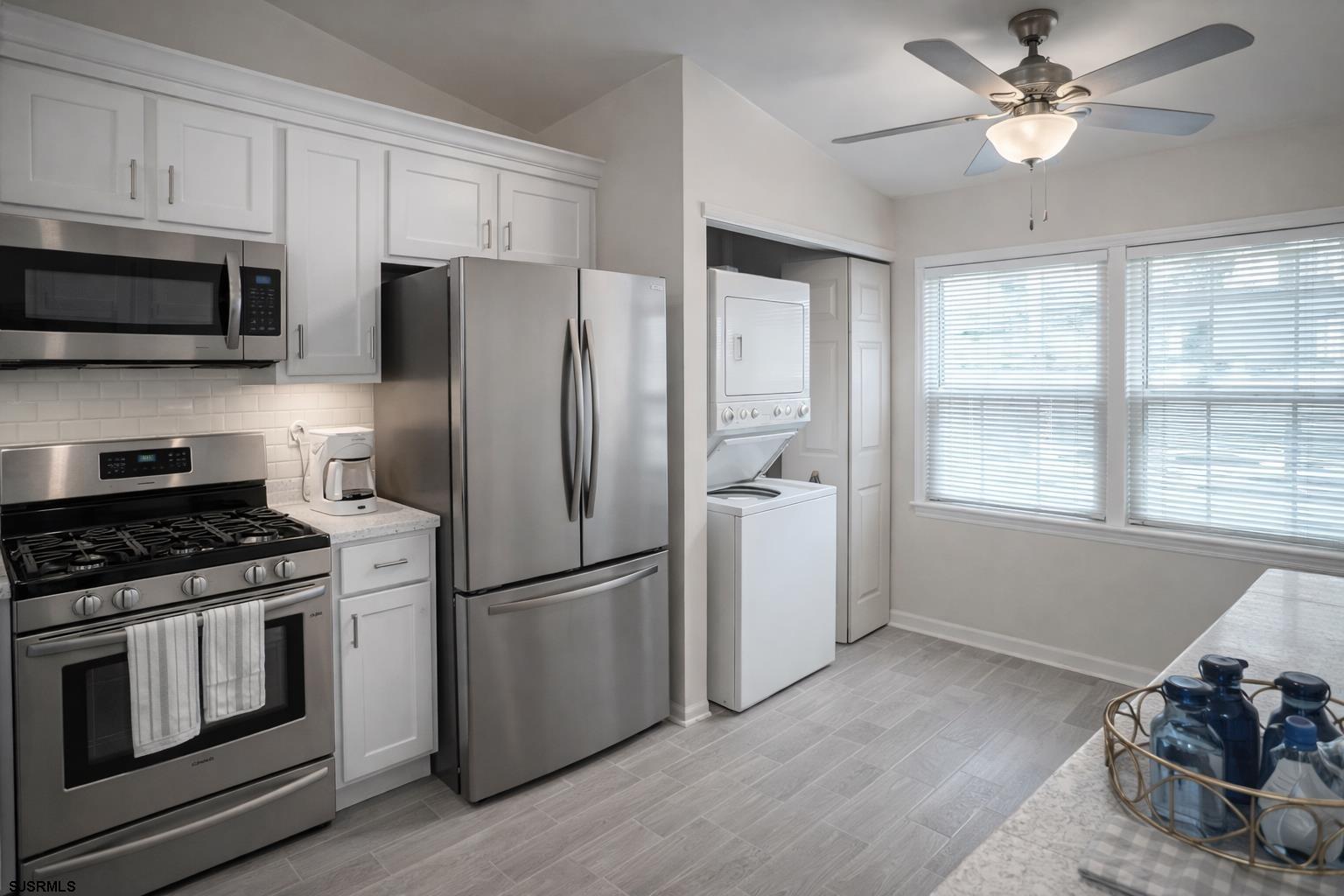 152 Club Place, Unit 152 Galloway Township, NJ 08205 - Photo 20 of 23 a kitchen with stainless steel appliances a stove a refrigerator and a microwave