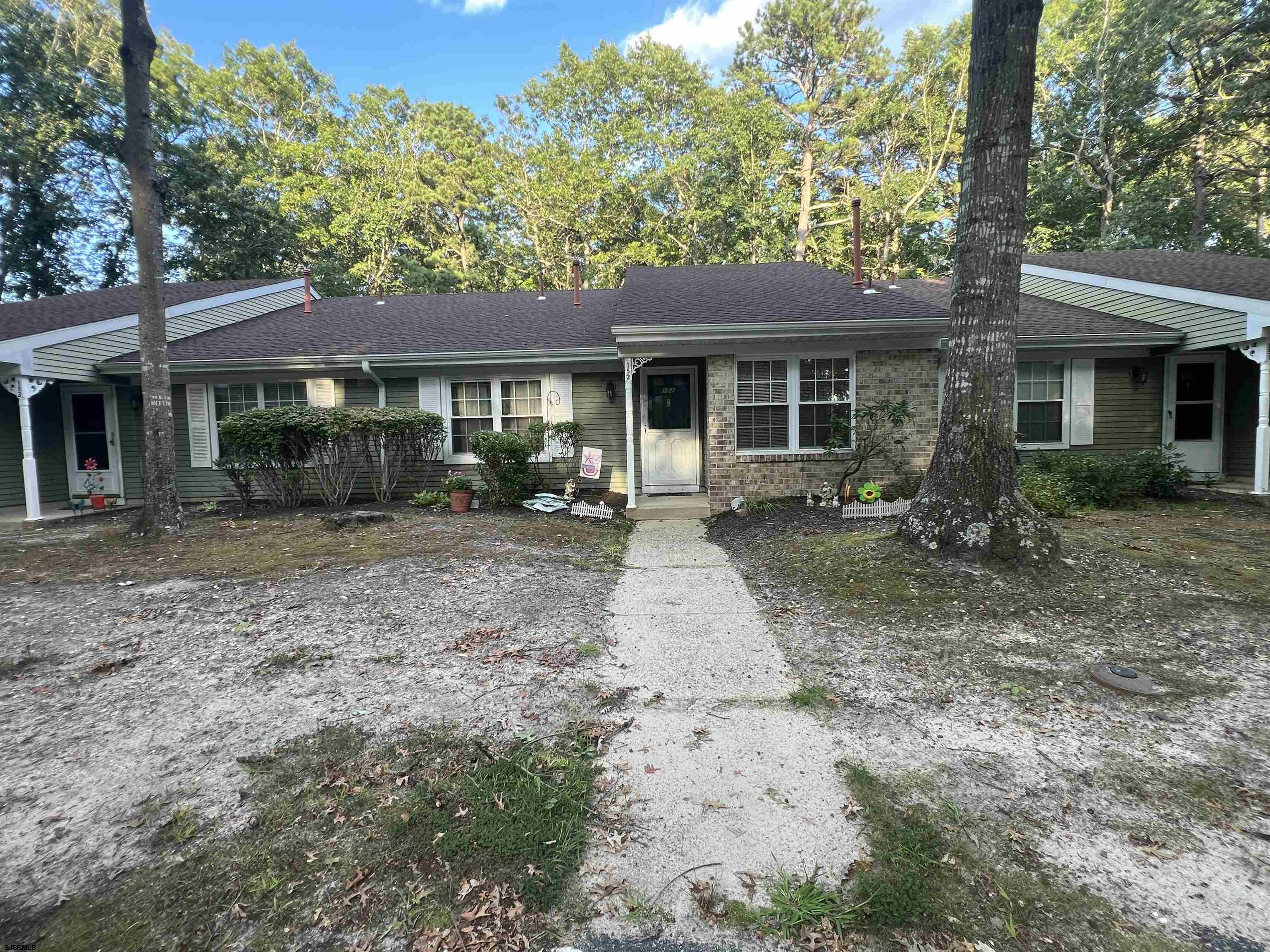 152 Club Place, Unit 152 Galloway Township, NJ 08205 - Photo 2 of 23 a front view of a house with garden