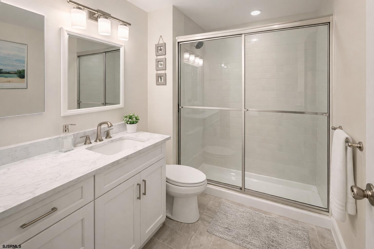 152 Club Place, Unit 152 Galloway Township, NJ 08205 - Photo 10 of 23 a bathroom with a granite countertop sink toilet and shower