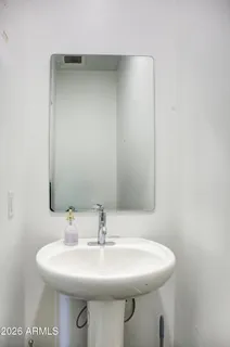 a bathroom with a sink a toilet and mirror