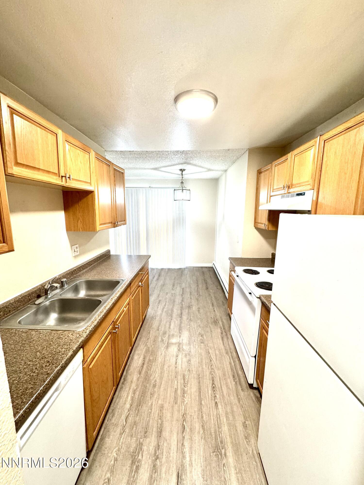 3880 East Leonesio Drive, Unit C2 Reno, NV 89512 - Photo 4 of 10 a view of a kitchen with a sink and wooden floor