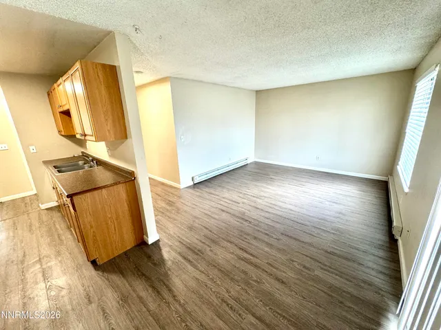 a view of a room with wooden floor and staircase