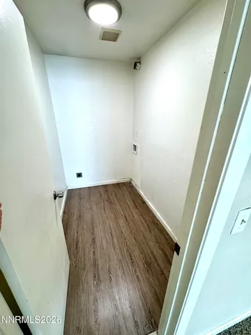 an empty room with wooden floor