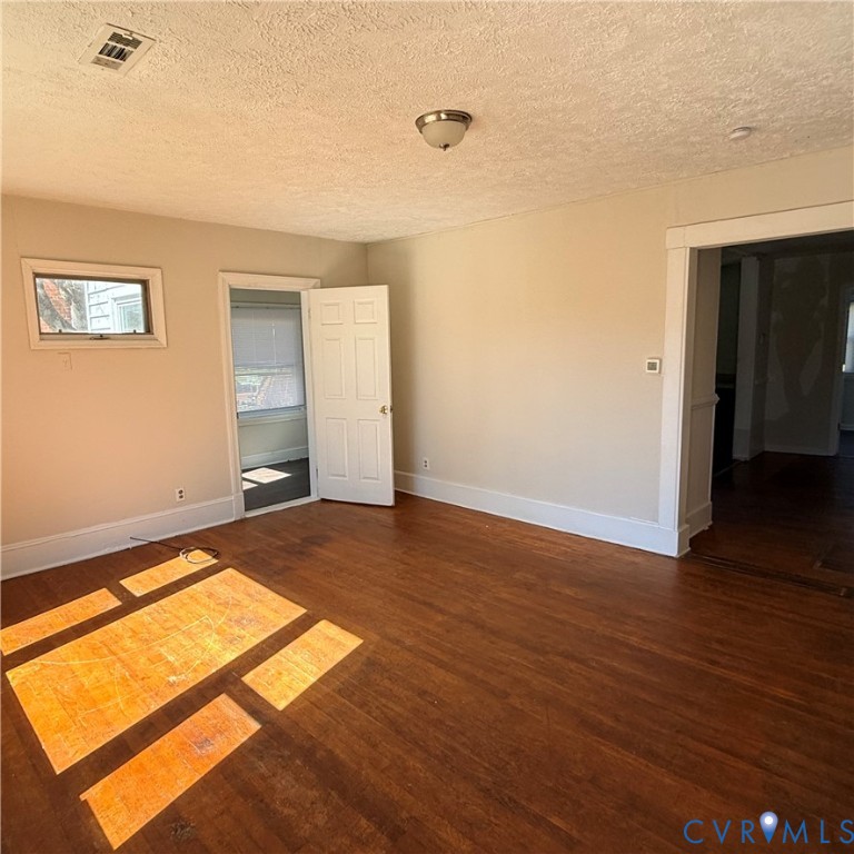2928 Springview Drive Richmond, VA 23234 - Photo 3 of 15 an empty room with wooden floor and windows