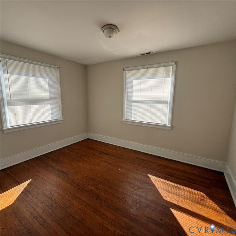 2928 Springview Drive Richmond, VA 23234 - Photo 10 of 15 a view of an empty room with wooden floor and a window
