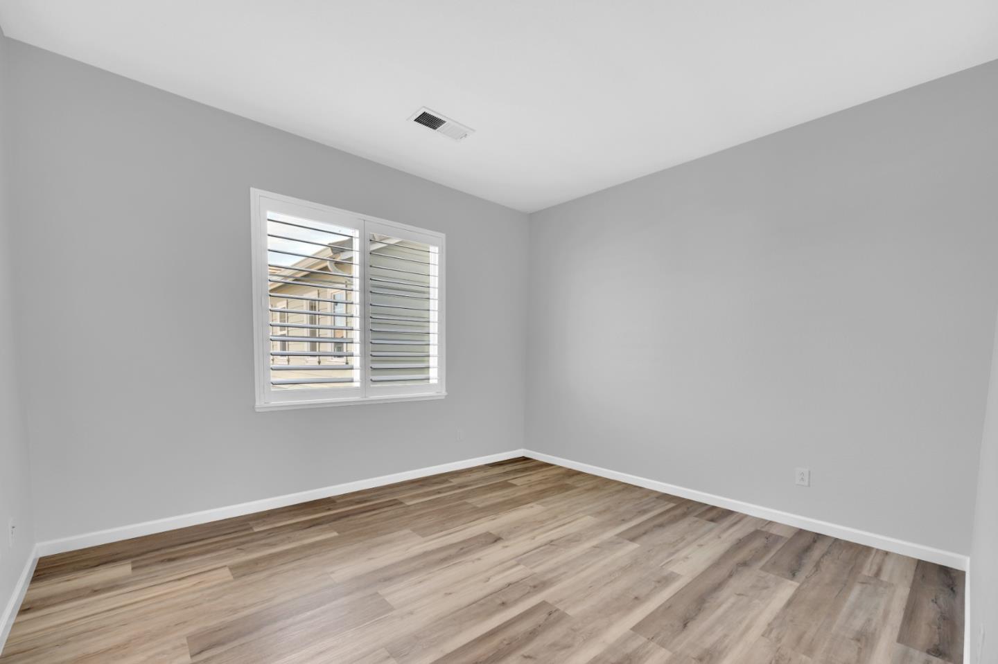 6367 Brando Loop Fair Oaks, CA 95628 - Photo 35 of 59 a view of an empty room with wooden floor and a window