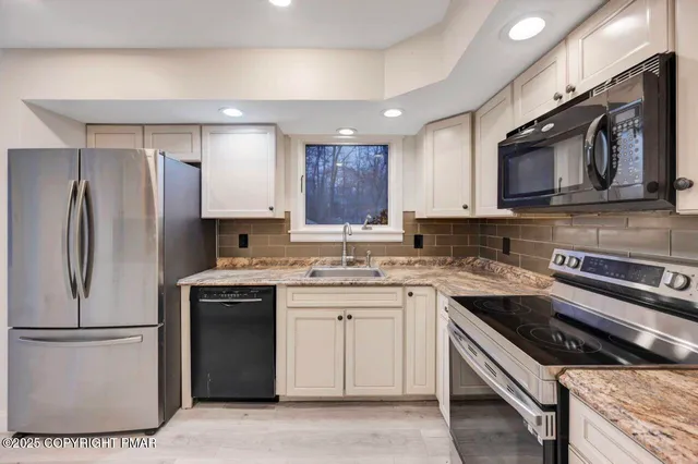 a view of an empty room with a window and closet