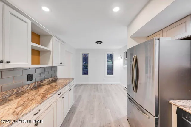 an empty room with windows and closet