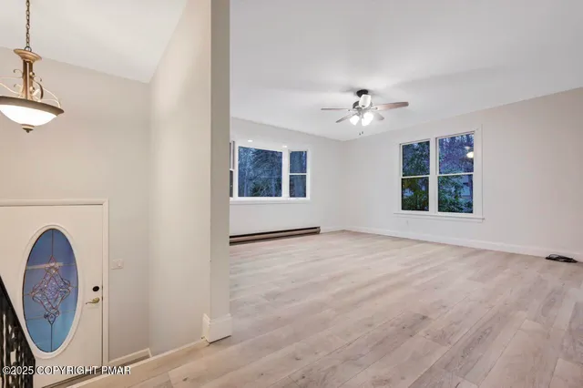 a view of a house with a yard covered in snow