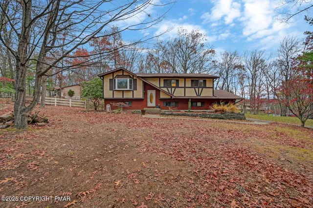 a view of a house with a yard covered in snow