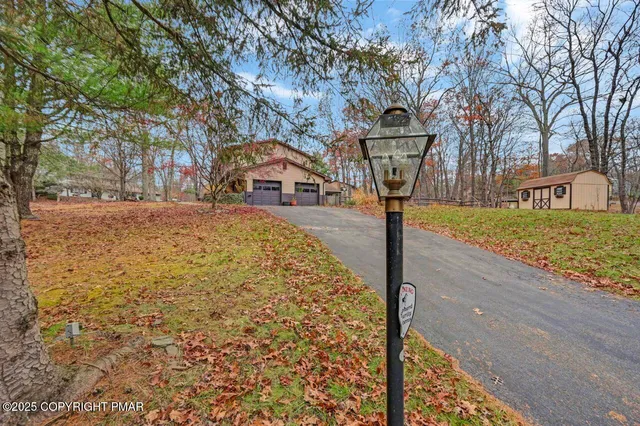a view of a house with a yard and sitting area
