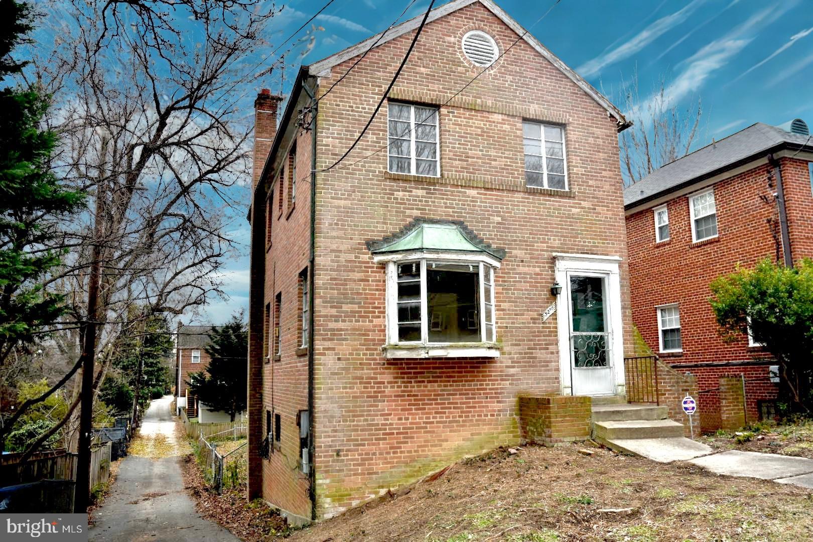 3210 Quesada Street Northwest Washington, DC 20015 - Photo 3 of 14 a front view of a house with a yard
