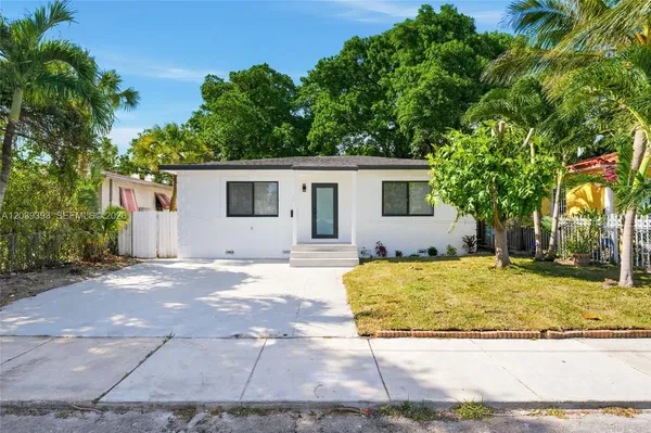 a view of a house with a yard covered in it